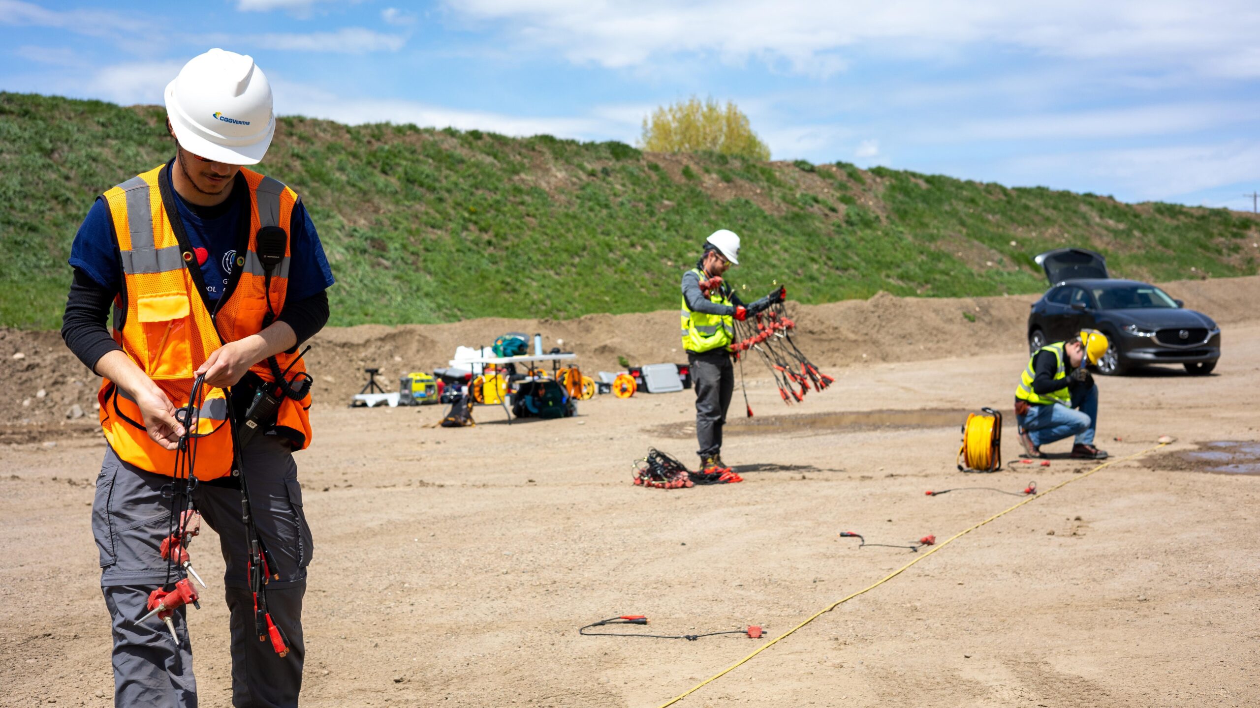 A group of men in hard hats and safety vests working on a construction site.