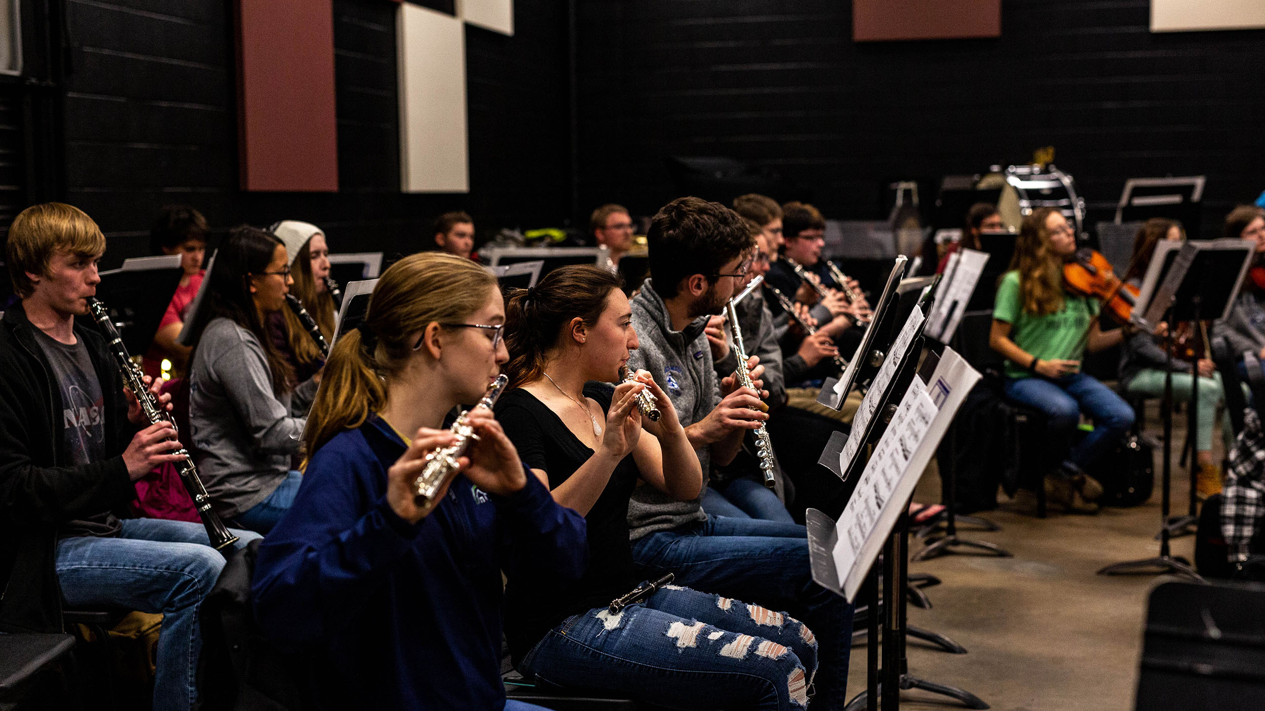 A group of people playing clarinets in a band.