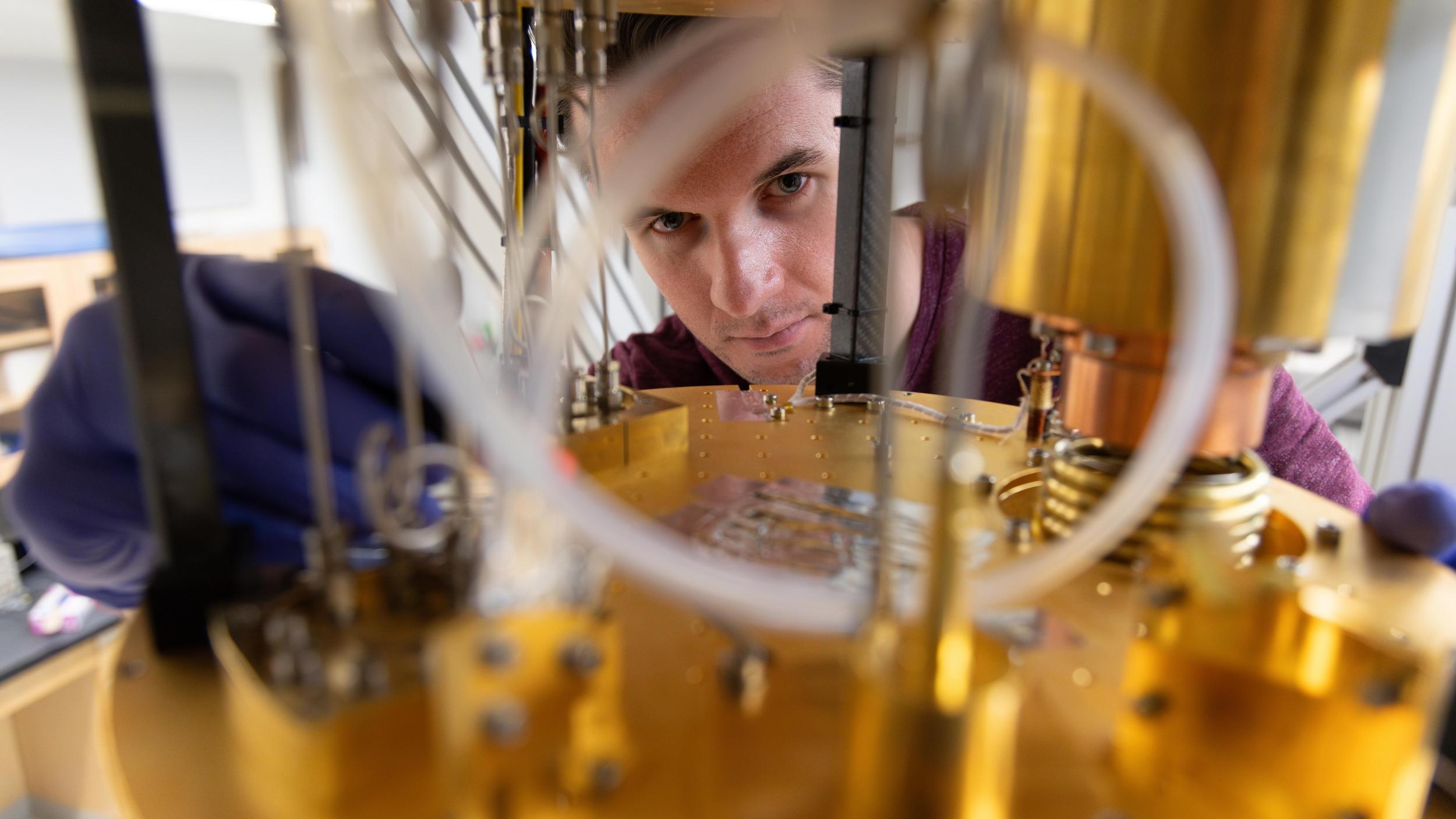 A man working on a machine in a laboratory.