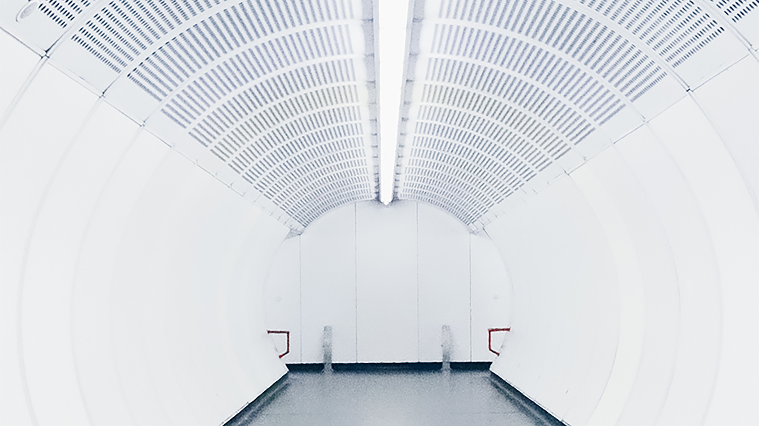 A long white tunnel with a light at the end.